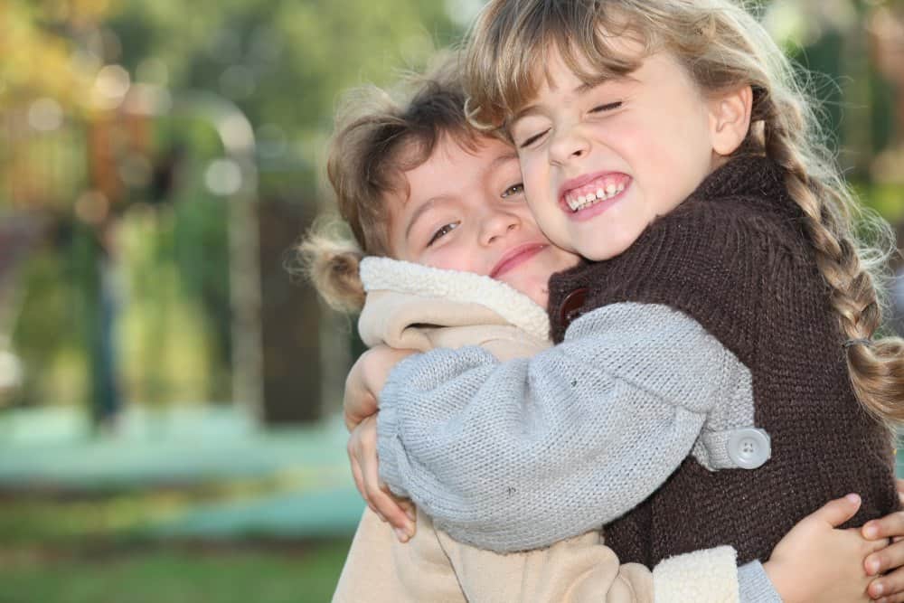 girls hugging for random acts of kindness at school