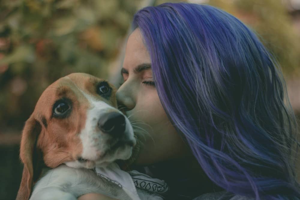 girl kissing her dog